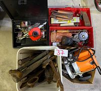 Overall view showing router, hand tools in bins and tub, and black toolbox with measuring tape inside.