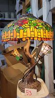 Full view of stained glass shade, tree bark base, and rose accent lights