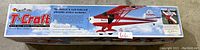 Box showing Great Planes T-Craft model airplane kit labeling with details about all wood construction and sport-scale aerobat design.