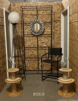 Photo showing full lot: floor lamp with globe and shelves, tubular metal and leather cantilever chair, wooden spools, and four martini glasses.