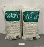 Two large bags of white styrofoam cushion beans with "CUSHION BEANS" label visible