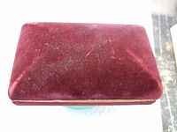 Closed original burgundy velvet watch case showing exterior condition.