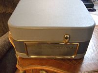 Closed rectangular grey case of the recorder showing case latches and case top.