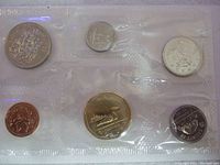 Front view of the 1992 uncirculated Canadian coin set sealed in clear plastic film, showing all coins visible and shiny.