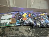 Three clear bags containing assorted electronic parts such as capacitors, chips, and memory modules placed on a surface.
