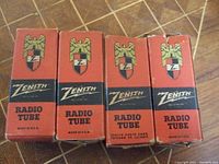 Photo of four vintage Zenith radio tube boxes lined up, showing front design with eagle logo and Zenith branding.