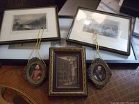 Six framed pictures displayed together showing variety of frames and pictures.