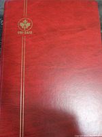 Front cover of Uni-Safe red stock album with gold markings