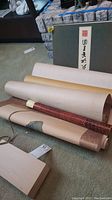Wooden box with scroll tubes and flat box containing tokens
