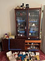 Full front view of two-piece rosewood veneer cabinet with contents inside