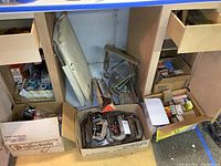 Boxes and drawers containing assorted clamps, hardware boxes, saw blades and tool accessories.