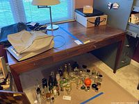 Front left perspective view of entire desk showing top surface, front drawer faces, and leg style