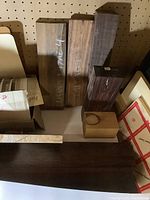 Four upright rectangular wood blanks against pegboard