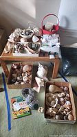 Overview of boxes showing geodes, seashells, bowl with rocks and red bucket