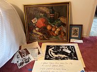 Three artworks displayed together: framed oil painting, unframed lino cut print and framed drawing with handwritten lot notes