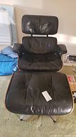 Front view of lounge chair and ottoman showing overall condition