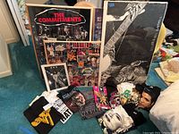 Posters and T-shirts arranged on floor showing all prints and garments