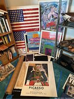 Overall group of nine posters leaning against bookshelves and display unit