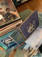 Stacked vinyl records with Beatles Rock 'n' Roll Music on top and Hank Williams albums adjacent