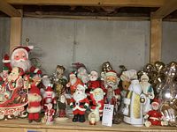 Left side view showing animated plastic Santa head, resin sleigh, and front-row gnome and figurines