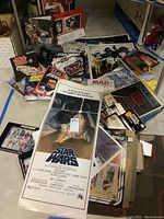 Overall view of laid-out posters, prints, magazines, blister pack