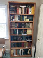 Full oak bookshelf with seven shelves filled with numerous Walt Whitman titles, showing overall lot.