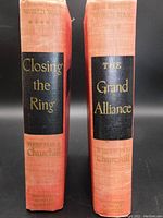 Front spine view of both books showing titles 'Closing the Ring' and 'The Grand Alliance' with red cloth binding and black title blocks with gold embossed lettering.