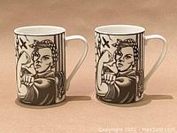 Pair of two black and white porcelain mugs showing Rosie the Riveter flexing arm image on front.