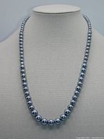 Front view of the gray/black pearl necklace displayed on a bust, showing graduated pearl sizes and lustrous surface.