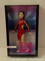 Front view of the new Tessa Virtue Barbie doll inside original sealed box showing red skating outfit and box artwork.