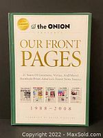 Front cover of The Onion's book titled 'Our Front Pages', showing publication years 1988-2008, with The Onion logo and gold text detailing its satirical nature.