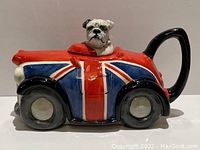 Front view showing bulldog head and Union Jack car body with black handle and wheels