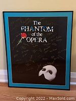 Full view of framed Phantom of the Opera poster with signatures and mat/frame details