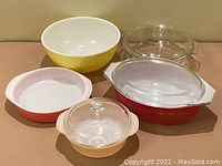 Photo showing all five mixing bowls and casserole dishes, varying in size and color: yellow, rose, red with gold, peach luster, and clear glass.
