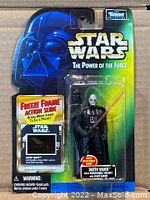 Front view of sealed Star Wars The Power of the Force Darth Vader action figure packaging showing the figure, removable helmet, lightsaber, and included freeze frame action slide.