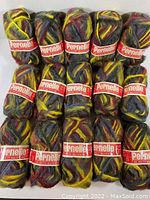 Photo showing all 15 skeins of multicolour Pernelle wool yarn arranged tightly together.