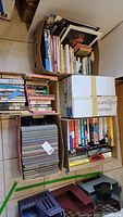 Five boxes of assorted books including hardback and paperback novels, art, travel, and historical subjects.