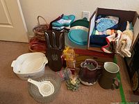 Photo showing entire lot with bowls, pitchers, carving set, linens and containers