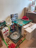 Overview of the boxed items, nativity scene, glassware, and holiday decor near the wall