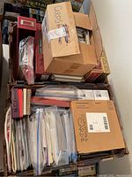 Three boxes stacked containing assorted cards and stationery. One box labeled 'CARDS', another labeled 'CHRISTMAS CARDS'.