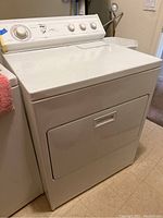 Front view of white Whirlpool electric dryer with control panel.