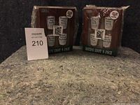 Photo of two unopened 4-pack shot glass sets with recipe labels visible on packaging.