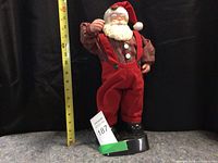 Front view of the battery operated singing and dancing Santa Claus figure showing detailed clothing and measurement for height.