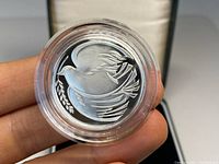 Close-up of the 1995 silver proof coin showing a dove with an olive branch.