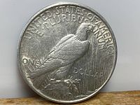 Reverse side of the 1922 American Silver Peace Dollar showing eagle perched on rock with inscriptions.