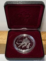 Canada silver dollar commemorative coin inside the original display box with red velvet interior.