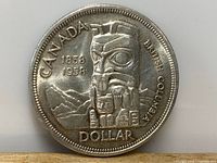 Obverse side showing Indigenous totem pole design with inscriptions