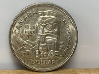 Obverse side of the coin showing indigenous totem design and denomination.
