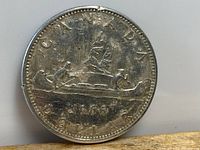Obverse showing date 1966, denomination and Voyageur design on Canadian silver dollar coin in protective holder.
