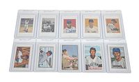 Top view of all 10 vintage baseball cards laid out in 2 rows of 5, all in plastic protectors, showing a variety of players and card art styles.